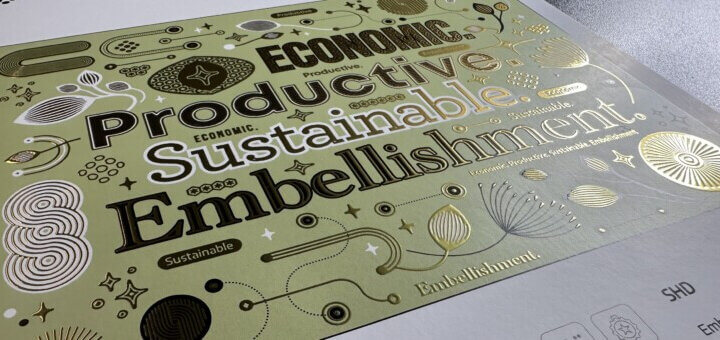 Gold postcard, embellished with feature words including sustainable, productive, economic, and embellishment with the angle of the image shining light on the gold embellishment. Image from Hampen Printing and PIWorld